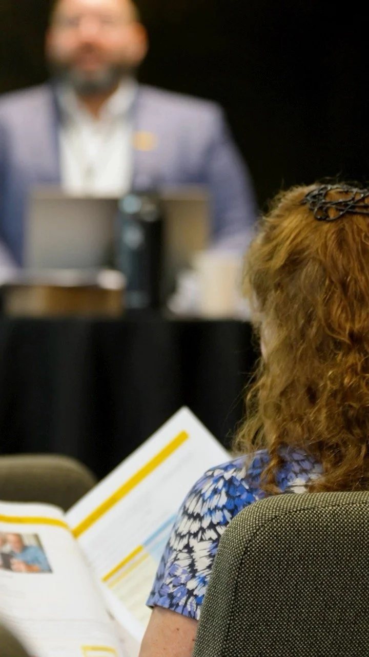 Attendees following along with printed programs