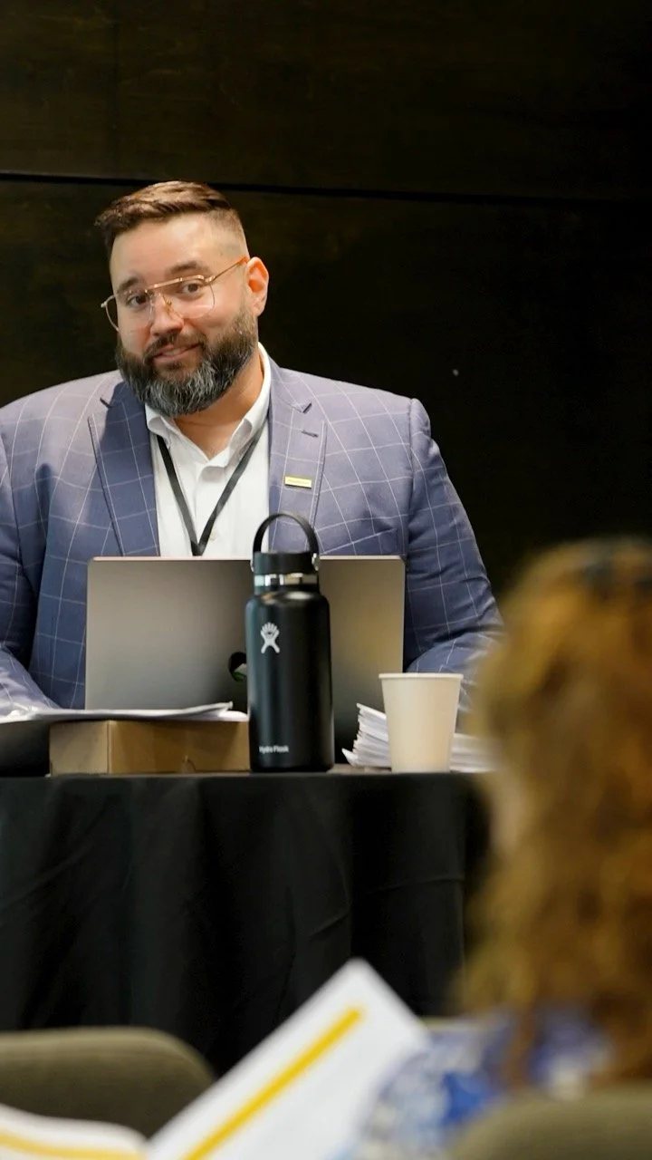 A speaker presenting to the room